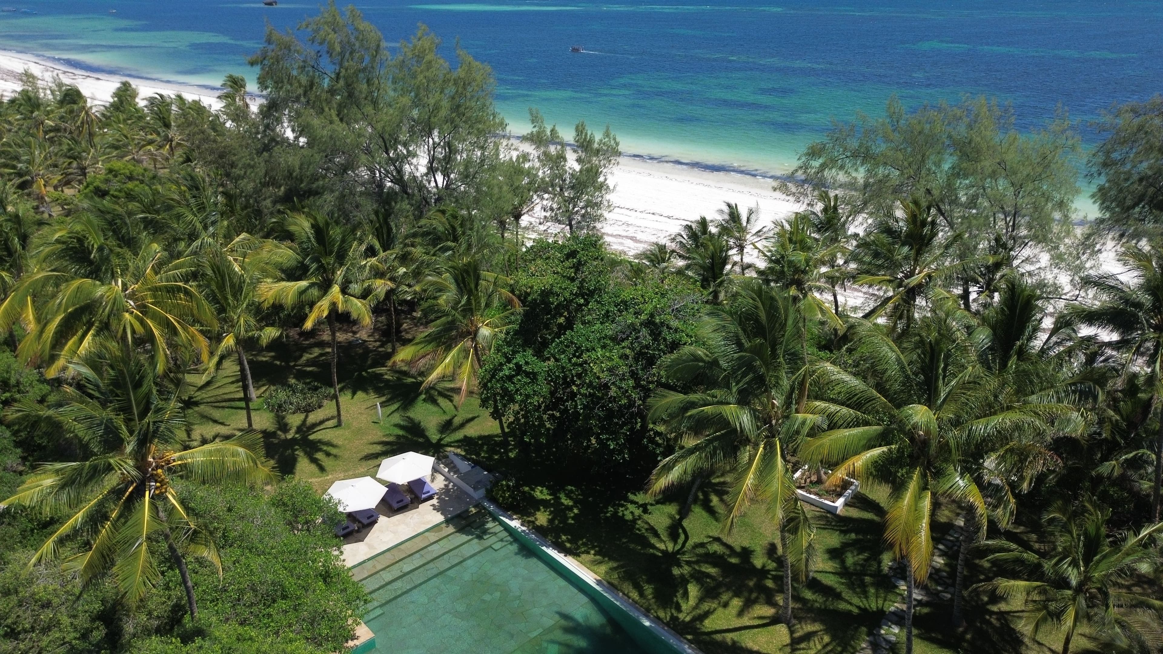 Emerald swimming pool surrounded by tropical gardens at Zuri Boutique Hotel, Watamu