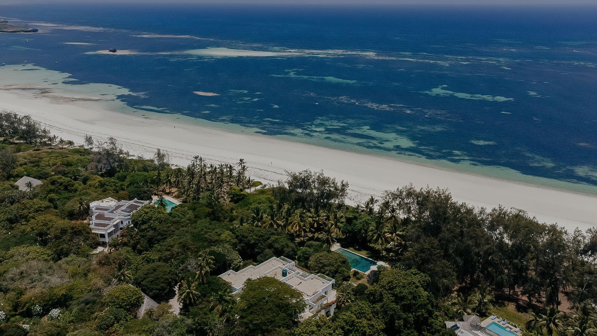 Quiet white sand beach lined with villas and palms between Turtle Bay and Garoda, Watamu